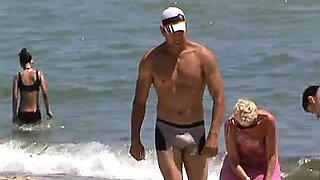 stranger rubs suntan lotion on wife at the beach